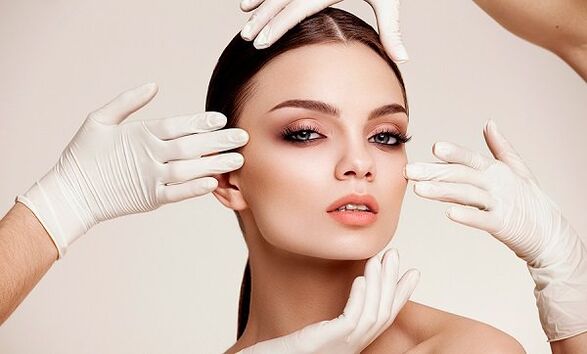 The hand of the glove on the girl's face